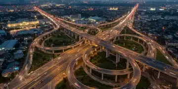 Modern highway interchange at dusk, representing infrastructure development