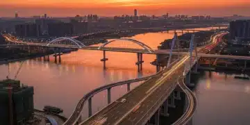 Modern highway bridge spanning a river at sunset, symbolizing new infrastructure